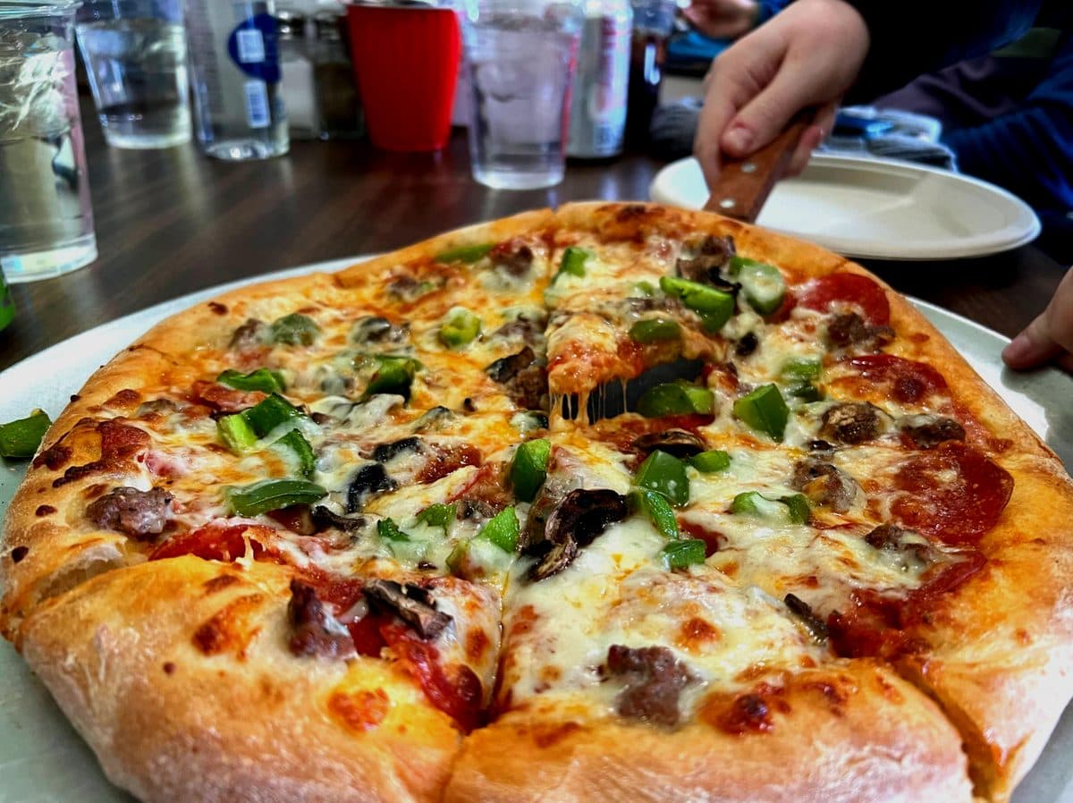 Fresh supreme pizza at Mario's Pizza